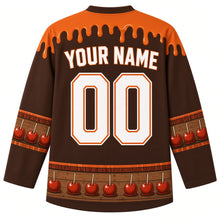Load image into Gallery viewer, Ugly Thanksgiving Caramel Apple Stand Hockey Jersey in Barnwood Brown, back view with a caramel-drip yoke, caramel apple and plaid sleeve bands, caramel apple and crate hem band, arched YOUR NAME lettering and 00 – custom name and number