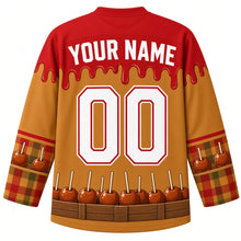Load image into Gallery viewer, Ugly Thanksgiving Caramel Apple Stand Hockey Jersey in Caramel Gold, back view with a caramel-drip yoke, caramel apple and plaid sleeve bands, caramel apple and crate hem band, arched YOUR NAME lettering and 00 – custom name and number