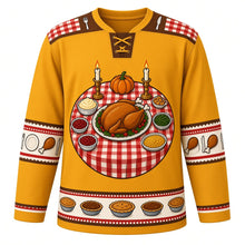 Load image into Gallery viewer, Ugly Thanksgiving Turkey Dinner Table Hockey Jersey in Roast Gold, front view – roast gold body with walnut brown yoke with a round crest of a dinner table seen from above with a golden roast turkey platter, candlesticks and side dishes, checkered tablecloth and cutlery yoke, plate and drumstick sleeve bands and a side-dish hem band – custom name and number