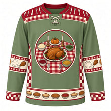 Load image into Gallery viewer, Ugly Thanksgiving Turkey Dinner Table Hockey Jersey in Sage Green, front view – sage green body with cranberry red yoke with a round crest of a dinner table seen from above with a golden roast turkey platter, candlesticks and side dishes, checkered tablecloth and cutlery yoke, plate and drumstick sleeve bands and a side-dish hem band – custom name and number