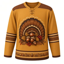 Load image into Gallery viewer, Ugly Thanksgiving Turkey Feather Fan Hockey Jersey in Wheat Gold, front view – wheat gold body with chestnut brown yoke with a round crest of a giant half-circle sunburst fan of barred bronze, copper, chestnut and cream turkey tail feathers with gold tips around a center cluster of acorns, oak leaves and red berries, feather-chevron yoke, striped-feather sleeve bands and a mini feather-fan and acorn hem band – custom name and number