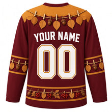 Load image into Gallery viewer, Ugly Thanksgiving Gratitude Leaf Garland Hockey Jersey in Burgundy, back view with a twine garland of oval leaves and acorns with clothespins over the yoke, matching leaf-and-acorn sleeve bands, a hem band of acorns, red berries and leaves, arched YOUR NAME lettering and 00 – custom name and number