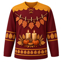 Load image into Gallery viewer, Ugly Thanksgiving Gratitude Leaf Garland Hockey Jersey in Burgundy, front view – burgundy body with goldenrod yoke with orange and tan lobed oak leaves and acorns on rustic twine with wooden clothespins, two glowing pillar candles over pumpkins with a mini pie, wheat and red berries, and oak-leaf sleeve and hem bands – custom name and number
