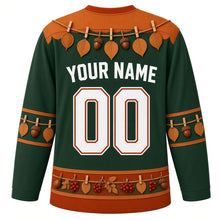 Load image into Gallery viewer, Ugly Thanksgiving Gratitude Leaf Garland Hockey Jersey in Forest Green, back view with a twine garland of oval leaves and acorns with clothespins over the yoke, matching leaf-and-acorn sleeve bands, a hem band of acorns, red berries and leaves, arched YOUR NAME lettering and 00 – custom name and number
