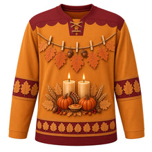 Load image into Gallery viewer, Ugly Thanksgiving Gratitude Leaf Garland Hockey Jersey in Goldenrod, front view – amber-gold goldenrod body with burgundy scalloped yoke with orange and tan lobed oak leaves and acorns on rustic twine with wooden clothespins, two glowing pillar candles over pumpkins with a mini pie, wheat and red berries, and oak-leaf sleeve and hem bands – custom name and number