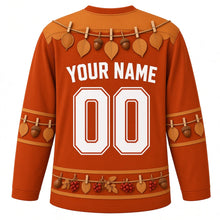 Load image into Gallery viewer, Ugly Thanksgiving Gratitude Leaf Garland Hockey Jersey in Rust Orange, back view with a twine garland of oval leaves and acorns with clothespins over the yoke, matching leaf-and-acorn sleeve bands, a hem band of acorns, red berries and leaves, arched YOUR NAME lettering and 00 – custom name and number