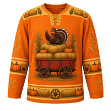 Load image into Gallery viewer, Ugly Thanksgiving Hayride Haystack Hockey Jersey in Pumpkin Orange, front view – pumpkin orange body with straw gold yoke with a hay wagon crest piled with hay bales, pumpkins and corn stalks with a cartoon turkey on top, hay-bale and corn yoke, pumpkin and corn sleeve bands and a hay-bale hem band – custom name and number