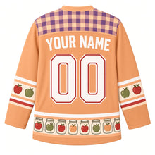 Load image into Gallery viewer, Ugly Thanksgiving Mason Jar Preserves Hockey Jersey in Peach Amber, back view with a fig purple and peach gingham yoke, red and green apple sleeve bands, a hem band of glass jars holding apples, arched YOUR NAME lettering and 00 – custom name and number