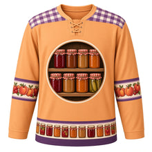 Load image into Gallery viewer, Ugly Thanksgiving Mason Jar Preserves Hockey Jersey in Peach Amber, front view – peach amber body with fig purple gingham yoke with a round crest of a rustic wooden pantry shelf of blank label-free glass canning jars glowing with cranberry jam, apple butter, peach preserves and pickles under red-and-white gingham lids, cream sleeve bands of peaches, apples and cranberries and a mini canning-jar hem band – custom name and number