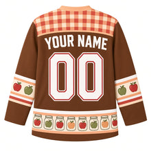 Load image into Gallery viewer, Ugly Thanksgiving Mason Jar Preserves Hockey Jersey in Apple Butter Brown, back view with a red and peach gingham yoke, red and green apple sleeve bands, a hem band of glass jars holding apples, arched YOUR NAME lettering and 00 – custom name and number