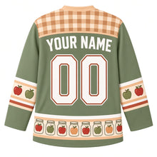 Load image into Gallery viewer, Ugly Thanksgiving Mason Jar Preserves Hockey Jersey in Sage Green, back view with a tan and cream gingham yoke, red and green apple sleeve bands, a hem band of glass jars holding apples, arched YOUR NAME lettering and 00 – custom name and number