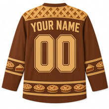 Load image into Gallery viewer, Ugly Thanksgiving Lattice Pie Bakery Hockey Jersey in Cinnamon Brown, back view with a golden lattice pie-crust yoke, mini lattice-pie and pie-slice sleeve bands, mini lattice-pie hem band, arched YOUR NAME lettering and 00 – custom name and number