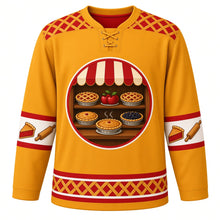 Load image into Gallery viewer, Ugly Thanksgiving Lattice Pie Bakery Hockey Jersey in Pie Crust Gold, front view – pie crust gold body with cherry red yoke with a round crest of a sign-free bakery window with a scalloped striped awning and wooden shelves of golden lattice-top cherry, apple and blackberry pies with a steaming pie on the sill, lattice-crust yoke, pie-slice and rolling-pin sleeve bands and a mini lattice-pie hem band – custom name and number