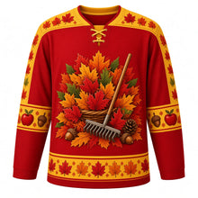 Load image into Gallery viewer, Ugly Thanksgiving Autumn Leaf Pile Hockey Jersey in Maple Red, front view – maple red body with golden yellow yoke with a round crest of a towering autumn leaf pile with a wooden rake, acorns and pinecones, swirling-leaf yoke, acorn and pinecone sleeve bands and a leaf-pile hem band – custom name and number