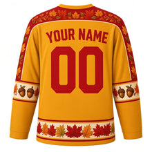 Load image into Gallery viewer, Ugly Thanksgiving Autumn Leaf Pile Hockey Jersey in Mustard Yellow, back view with a swirling-leaf yoke, acorn and pinecone sleeve bands, leaf-pile hem band, arched YOUR NAME lettering and 00 – custom name and number