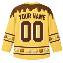 Load image into Gallery viewer, Ugly Thanksgiving Mashed Potato Mountain Hockey Jersey in Butter Yellow, back view with a gravy-drip yoke, biscuit and butter-pat sleeve bands, mashed potato bowl and biscuit hem band, brown arched YOUR NAME lettering and brown 00 – custom name and number