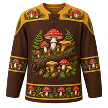 Load image into Gallery viewer, Ugly Thanksgiving Wild Mushroom Forest Hockey Jersey in Bark Brown, front view – bark brown body with mustard gold yoke with a round crest of a mossy fallen log sprouting red spotted toadstools, golden chanterelles and button mushrooms among ferns and oak leaves, toadstool-and-fern yoke, mushroom and acorn sleeve bands and a mushroom-cluster hem band – custom name and number