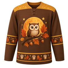 Load image into Gallery viewer, Ugly Thanksgiving Harvest Moon Owl Hockey Jersey in Barn Owl Brown, front view – barn owl brown body with harvest gold yoke with a round crest of a fluffy wide-eyed cartoon owl on an acorn-laden oak branch before a giant orange harvest moon, feather-and-star yoke, acorn and oak-leaf sleeve bands and an owl-and-moon hem band – custom name and number