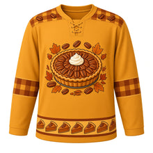 Load image into Gallery viewer, Ugly Thanksgiving Pecan Pie Plaid Hockey Jersey in Butterscotch Gold, front view – butterscotch gold body with toasted brown and rust plaid yoke with a round glossy pecan pie crest with whipped cream, flannel-check plaid yoke, plaid-and-pecan sleeve bands and a pie-slice plaid hem band – custom name and number