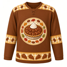 Load image into Gallery viewer, Ugly Thanksgiving Pecan Pie Plaid Hockey Jersey in Toasted Pecan, front view – toasted pecan brown body with butterscotch gold and cream plaid yoke with a round glossy pecan pie crest with whipped cream, flannel-check plaid yoke, plaid-and-pecan sleeve bands and a pie-slice plaid hem band – custom name and number