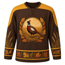 Load image into Gallery viewer, Ugly Thanksgiving Woodland Pheasant Brush Hockey Jersey in Woodland Brown, front view – brown body with a gold yoke running down the outer sleeves, oval crest of a ring-necked pheasant in golden grass framed by oak leaves, grass prints on the lower sleeve bands and an oak leaf hem band – custom name and number