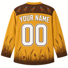 Load image into Gallery viewer, Ugly Thanksgiving Woodland Pheasant Brush Hockey Jersey in Grassland Gold, back view – gold body with a brown yoke showing a row of small pheasants and a golden grass scene on the lower sleeves and hem with YOUR NAME and 00 – custom name and number