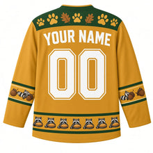 Load image into Gallery viewer, Ugly Thanksgiving Autumn Raccoon Raid Hockey Jersey in Harvest Gold, back view with a forest green paw-print and leaf yoke, raccoon and acorn sleeve bands, a raccoon-and-pie hem band, YOUR NAME lettering and 00 – custom name and number