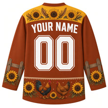 Load image into Gallery viewer, Ugly Thanksgiving Farmhouse Rooster Hockey Jersey in Rust Brown, back view with a sunflower-and-feather yoke, fence-rail and sunflower sleeve bands, rooster, hen and sunflower hem band, arched YOUR NAME lettering and 00 – custom name and number
