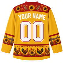 Load image into Gallery viewer, Ugly Thanksgiving Farmhouse Rooster Hockey Jersey in Sunflower Yellow, back view with a sunflower-and-feather yoke, fence-rail and sunflower sleeve bands, rooster, hen and sunflower hem band, arched YOUR NAME lettering and 00 – custom name and number