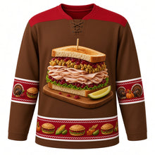Load image into Gallery viewer, Ugly Thanksgiving Leftover Sandwich Stack Hockey Jersey in Toasted Rye, front view – toasted rye brown body with cranberry red yoke with a towering leftover sandwich on a wooden cutting board with sliced roast turkey, stuffing, cranberry sauce and lettuce between toasted bread slices, a wooden toothpick and a pickle wedge, roast turkey, mini-sandwich and pumpkin sleeve bands and a mini-sandwich, corn and pumpkin hem band – custom name and number