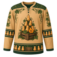 Load image into Gallery viewer, Ugly Thanksgiving Butternut Squash Stack Hockey Jersey in Butternut Tan, front view – butternut tan body with forest green yoke with a round crest of a teetering tower of butternut squashes stacked on a wooden crate with curling green vines and leaves and a halved squash showing orange flesh and seeds, squash-seed and vine yoke, mini butternut sleeve bands and a butternut-and-crate hem band – custom name and number