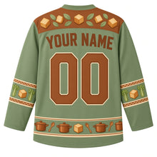 Load image into Gallery viewer, Ugly Thanksgiving Stuffing Stockpot Hockey Jersey in Sage Green, back view with a bread-cube and sage-leaf yoke, celery and bread-cube sleeve bands, a hem of mini stockpots and spoons, arched YOUR NAME lettering and 00 – custom name and number
