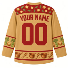 Load image into Gallery viewer, Ugly Thanksgiving Stuffing Stockpot Hockey Jersey in Toasted Gold, back view with a bread-cube and sage-leaf yoke, celery and bread-cube sleeve bands, a hem of copper bowls and spoons, arched YOUR NAME lettering and 00 – custom name and number