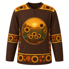 Load image into Gallery viewer, Ugly Thanksgiving Sunflower Harvest Field Hockey Jersey in Chocolate Brown, front view – chocolate brown body with sunflower gold yoke with a round crest of a glowing sunflower field at golden hour with rows of tall sunflowers, a low golden sun and a woven harvest basket overflowing with cut sunflower heads, sunflower-seed yoke, sunflower-and-leaf sleeve bands and a sunflower-head hem band – custom name and number