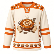 Load image into Gallery viewer, Ugly Thanksgiving Sweet Potato Casserole Hockey Jersey in Marshmallow Cream, front view – marshmallow cream body with sweet potato orange yoke with a round crest of a steaming sweet potato casserole topped with toasted marshmallows and pecans, framed by oven mitts and a serving spoon, marshmallow-and-pecan yoke, sweet potato sleeve bands and a mini casserole hem band – custom name and number