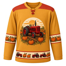 Load image into Gallery viewer, Ugly Thanksgiving Pumpkin Patch Tractor Hockey Jersey in Hay Gold, front view – hay gold body with tractor red yoke with a round-topped crest of an unbranded vintage red farm tractor with big rear tires and a tall exhaust stack driving down a dirt row through a pumpkin patch with curly vines under a low orange sun, a tire-tread chevron yoke, red-trimmed cream pumpkin-vine sleeve bands and a red-trimmed cream tiny tractor and pumpkin hem band – custom name and number