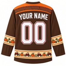 Load image into Gallery viewer, Ugly Thanksgiving Pumpkin Patch Tractor Hockey Jersey in Walnut Brown, back view with a black tire-track yoke, orange-trimmed cream pumpkin-vine sleeve bands, an orange-trimmed cream tiny tractor and pumpkin hem band, arched YOUR NAME lettering and 00 – custom name and number