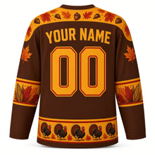 Load image into Gallery viewer, Ugly Thanksgiving Strutting Turkey Hockey Jersey in Chestnut Brown, back view with a feather-and-acorn yoke, feather and corn sleeve bands, strutting-turkey hem band, arched YOUR NAME lettering and 00 – custom name and number