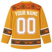 Load image into Gallery viewer, Ugly Thanksgiving Pumpkin Wagon Haul Hockey Jersey in Hay Gold, back view with a wagon-wheel and pumpkin yoke, wooden-plank bands with pumpkins on the sleeves and hem, arched YOUR NAME lettering and 00 – custom name and number