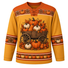 Load image into Gallery viewer, Ugly Thanksgiving Pumpkin Wagon Haul Hockey Jersey in Hay Gold, front view – hay gold body with rust orange yoke with a wooden spoked-wheel wagon full of orange and white pumpkins with autumn leaves, wagon-wheel and pumpkin yoke, wagon-wheel and pumpkin sleeve bands and a pumpkin hem band – custom name and number