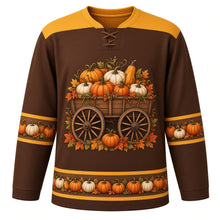 Load image into Gallery viewer, Ugly Thanksgiving Pumpkin Wagon Haul Hockey Jersey in Walnut Brown, front view – walnut brown body with hay gold yoke with a wooden spoked-wheel wagon full of orange and white pumpkins with autumn leaves, wagon-wheel and pumpkin yoke, wagon-wheel and pumpkin sleeve bands and a pumpkin hem band – custom name and number