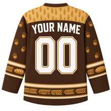 Load image into Gallery viewer, Ugly Thanksgiving Golden Wheat Sheaf Hockey Jersey in Toasted Brown, back view with a wheat-ear yoke, braided-wheat and bread-loaf sleeve bands, tied wheat-bundle hem band, arched YOUR NAME lettering and 00 – custom name and number