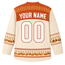 Load image into Gallery viewer, Ugly Thanksgiving Golden Wheat Sheaf Hockey Jersey in Harvest Cream, back view with a wheat-ear yoke, braided-wheat and bread-loaf sleeve bands, tied wheat-bundle hem band, arched YOUR NAME lettering and 00 – custom name and number