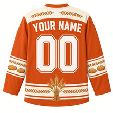 Load image into Gallery viewer, Ugly Thanksgiving Golden Wheat Sheaf Hockey Jersey in Rust Orange, back view with a wheat-ear yoke, braided-wheat and bread-loaf sleeve bands, tied wheat-bundle hem band, arched YOUR NAME lettering and 00 – custom name and number