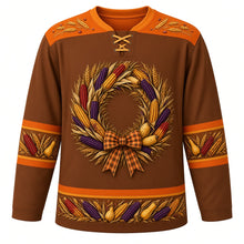 Load image into Gallery viewer, Ugly Thanksgiving Calico Corn Wreath Hockey Jersey in Chestnut Brown, front view – chestnut brown body with pumpkin orange yoke with a round wreath of speckled red, purple and gold calico corn ears, wheat stalks and small gourds tied with a plaid bow, a wheat-sprig yoke and calico corn and gourd sleeve and hem bands – custom name and number