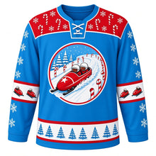 Load image into Gallery viewer, Ugly Christmas Bobsled Snow Run Hockey Jersey in Ice Blue, front view – round crest of a red two-person bobsled with a white star on its nose racing down a snowy track lined with candy canes and pine trees, red yoke of candy canes and snowflakes, snowflake sleeves with little bobsled elbow bands and a blue pine tree hem band – custom name and number