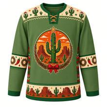 Load image into Gallery viewer, Ugly Christmas Desert Cactus Christmas Hockey Jersey in Saguaro Green, front view – ornament-covered saguaro with a gold star topper against an orange desert sunset and red buttes, framed by a twig wreath and red bow, Santa-hat cactus yoke, chili and wreath sleeve bands and a desert mesa hem band – custom name and number