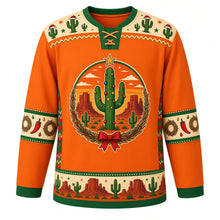 Load image into Gallery viewer, Ugly Christmas Desert Cactus Christmas Hockey Jersey in Sunset Orange, front view – round crest of a saguaro cactus decorated with ornaments and a gold star under a sunset sky with red mesas, in a woven wreath with a red bow, cream Santa-hat cactus yoke, cream chili pepper and wreath sleeve bands and a saguaro and mesa hem band – custom name and number