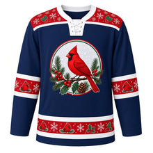 Load image into Gallery viewer, Ugly Christmas Cardinal Snowfall Hockey Jersey in Winter Navy, front view – winter navy body with red holly-and-snowflake yoke with a round crest of a red cardinal on a snowy pine branch with berries, holly and a pinecone, plus round-cardinal, snowflake and holly bands – custom name and number