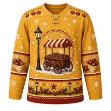 Load image into Gallery viewer, Ugly Christmas Roasted Chestnut Cart Hockey Jersey in Lamplight Gold, front view – lamplight gold body with a chestnut-and-snowflake yoke with an old-fashioned striped-awning street cart of steaming roasted chestnuts beside a glowing street lamp in the snow, plus paper cones of chestnuts on the sleeves and a street lamp and holly hem band – custom name and number